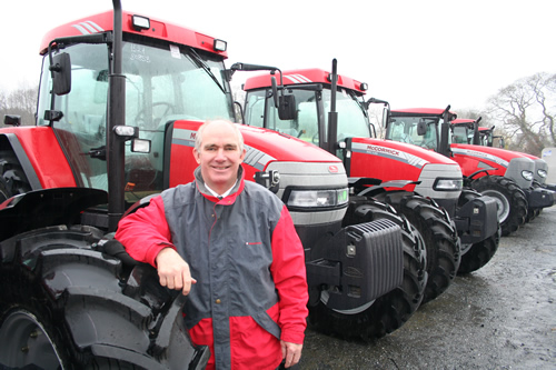 Dave Hill at Riverlea’s Whitland branch with a line-up of new McCormick tractors.